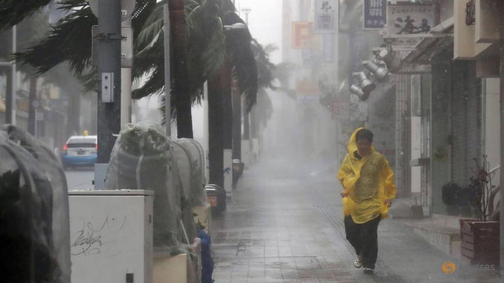a-passer-by-walks-in-heavy-rain-and-wind-caused-by-typhoon-trami-in-the-prefectural-capital-naha--on-the-southern-island-of-okinawa--in-this-photo-taken-by-kyodo-1.jpg