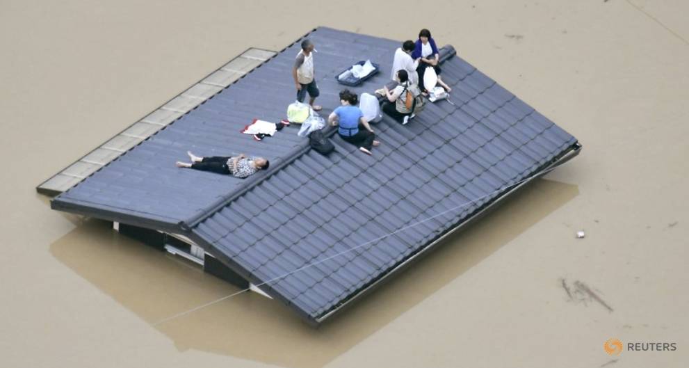 an-aerial-view-shows-local-residents-seen-on-the-roof-of-submerged-house-at-a-flooded-area-as-they-wait-for-a-rescue-in-kurashiki-1.jpg